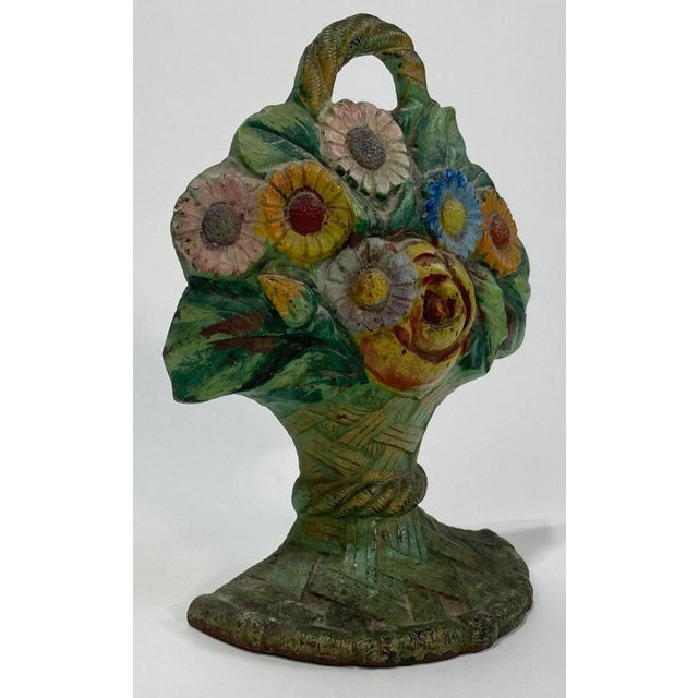 Substantial vintage 9.5"H cast iron door stop resembling lovely floral bouquet in basket. Rich colors to this piece. Great...