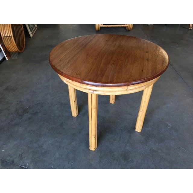 Restored round Mid-century rattan Child's Dining/Play Table with a mahogany top featuring four-strand table legs. 1950,...