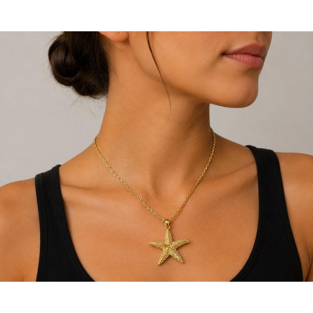 Detailed 14k yellow gold pendant in the shape of a textured starfish. 3.43g