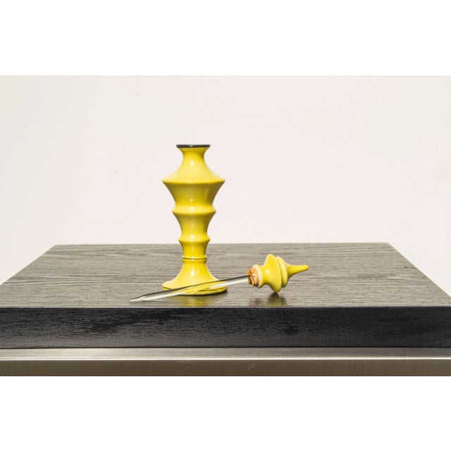 A petite and elegant yellow ceramic perfume bottle from Bavaria (Germany). A glass wand extends from the bottle's top,...