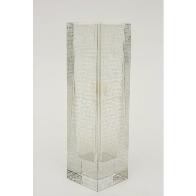 This mesmerizing modern glass clear column vase with white has row after row of different spiritual words in lines...
