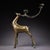 This is an ornate cast bronze candelabra in the form of a standing deer, featuring extensive gold inlay (gilt bronze)...