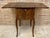 French side table with wings in walnut wood with roots decoration. with a folding door on one side that have a wooden...