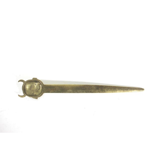 Vintage brass letter opener in the shape of a laughing devil. The blade is beautifully etched with a foliage pattern. This...