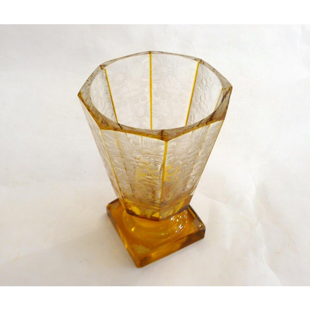 Art Deco vase on a pedestal, with a thick square base and an eight-sided flared body, entirely decorated with a rich,...