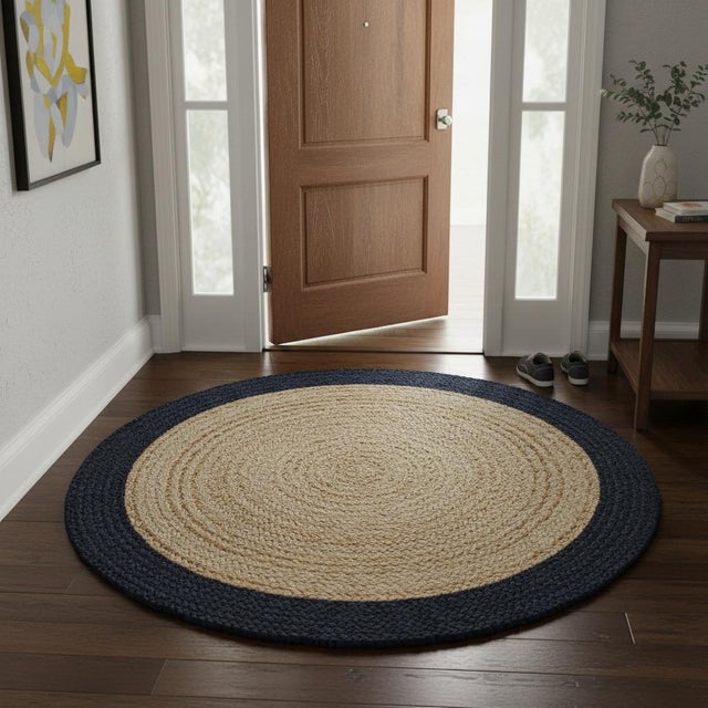 This handcrafted round jute doormat brings natural texture and understated elegance to any entryway. Woven from durable...