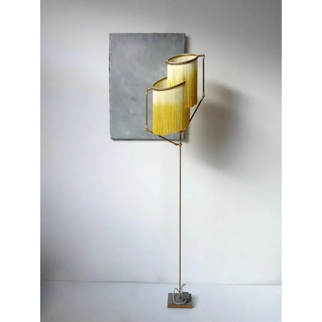 Yellow charme floor lamp, sander bottinga dimensions: h 153 x w 38 x d 25 cm handmade in brass, leather, wood and dip dyed...