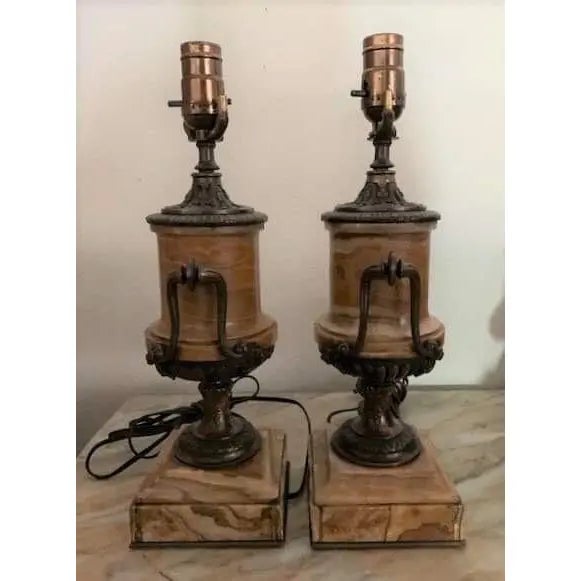 A pair of Italian marble and bronze table lamps dating from the turn of the 20th century. Turned marble urns sit in cast...
