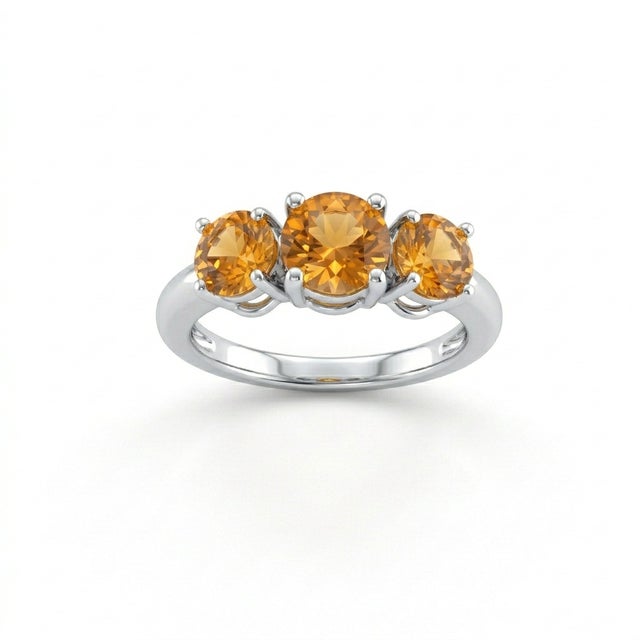 This striking ring showcases three brilliant round-cut citrine gemstones, each radiating a warm, golden yellow hue that...
