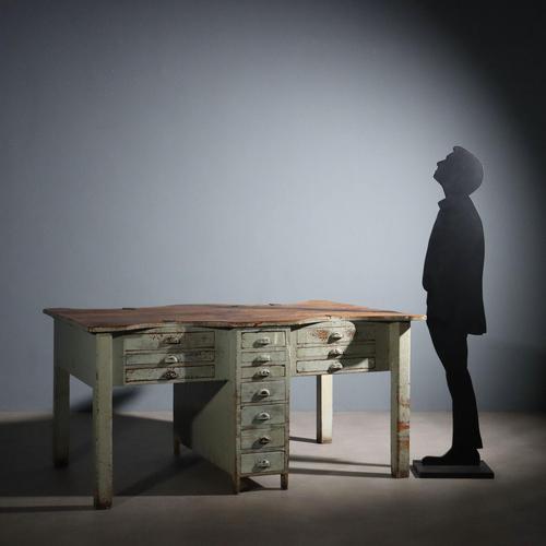 Workbench with four workstations. Four legs and a central drawer unit with four feet support the top, beneath which are...