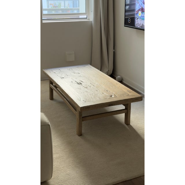 Substantial solid poplar coffee table with a low, architectural profile and traditional stretcher construction. The...