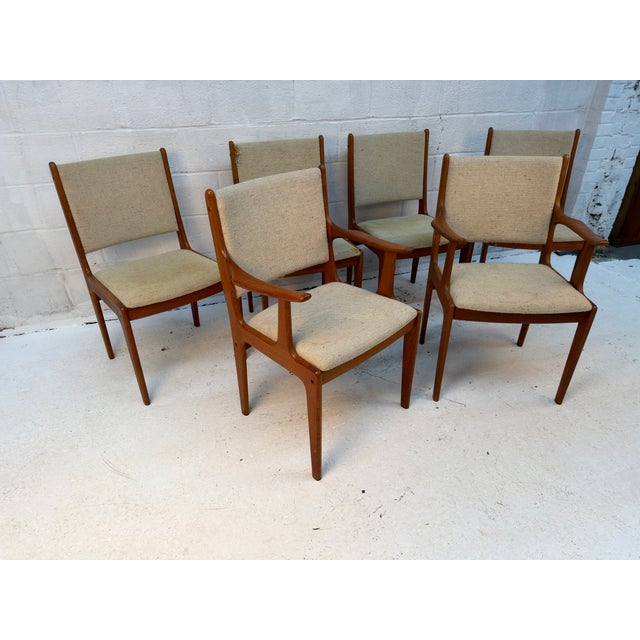 A timeless set of six Mid-Century Modern dining chairs by Scandinavia Woodworks, showcasing the warm tones and beautifully...