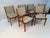 A timeless set of six Mid-Century Modern dining chairs by Scandinavia Woodworks, showcasing the warm tones and beautifully...
