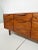 A mid century walnut media cabinet, credenza or dresser by the Danish American designer Jens Risom, circa 1960s. Top three...