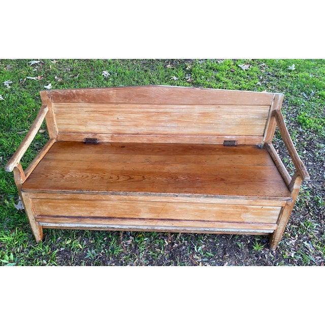 This antique wooden bench was handcrafted of solid pine by a Mennonite carpenter, and converts into a trundle bed (the...
