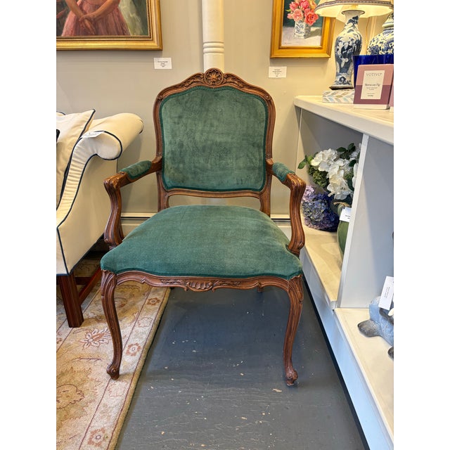This is a French Louis XV style vintage chair. It has newly reupholstered velvet fabric with green gimp. The wood is...
