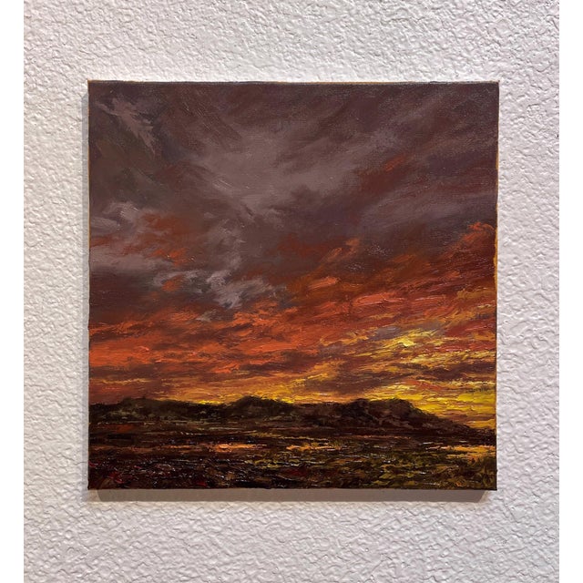 This artwork depicts a dramatic sunset over a rugged landscape, where rich hues of orange and deep red blend seamlessly...