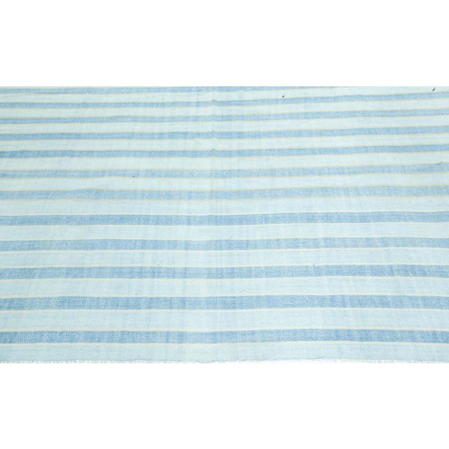 Vintage Indian Dhurrie Rug – Subtle Striped Elegance in Sky Blue and Ivory Size: 9'4" × 13'6" (284 × 411 cm) Effortlessly...