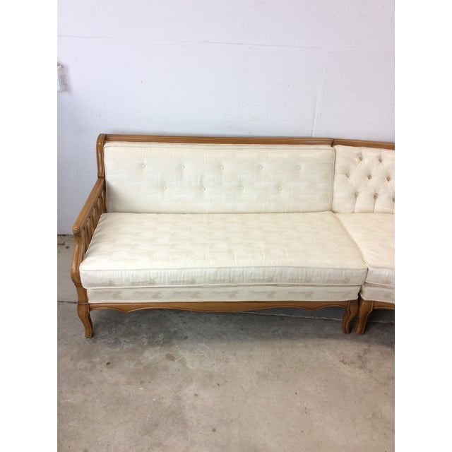 This mid century modern three piece sectional sofa features hardwood frame, vintage tufted upholstery, curved design atop...
