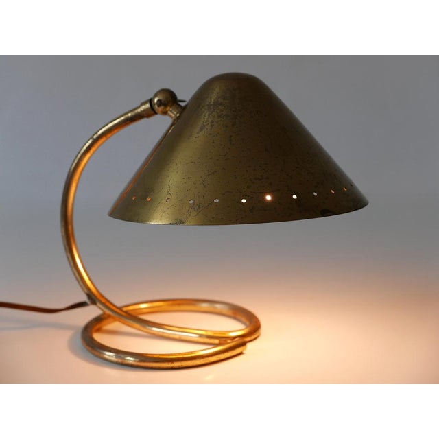 Small and elegant mid-century modern table lamp with adjustable shade. It can be used as wall light as well. Designed and...