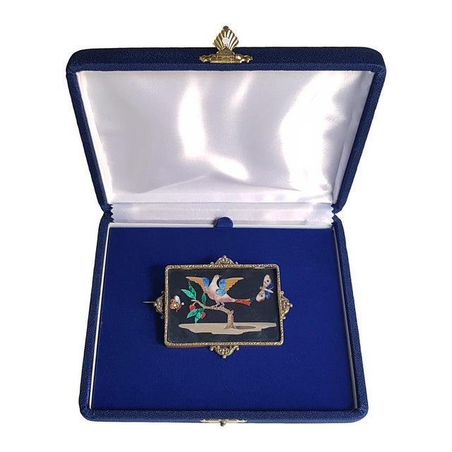 Black marble finely inlaid with polychrome marbles and semiprecious stones. Designed as a pin. Florence, 19th century....