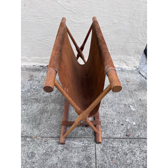 A beautifully resolved object from the Danish modern export era — teak dowels crossing at a brass pivot bolt, a single...