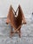 A beautifully resolved object from the Danish modern export era — teak dowels crossing at a brass pivot bolt, a single...