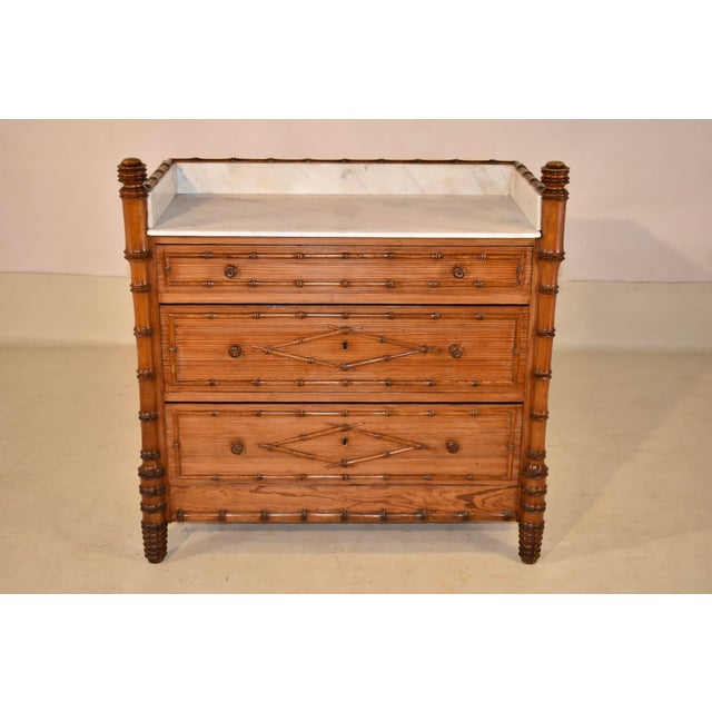 19th Century faux bamboo chest with marble top from France. The top is decorated with hand-turned finials and a three...