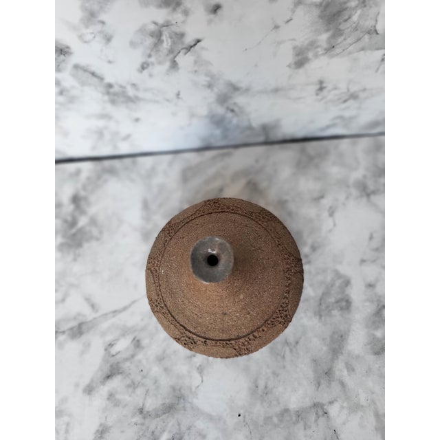 Here, a petite, textured, amorphous bud vase, in a beautiful clay color. brings The tactile nature sculpted into this high...
