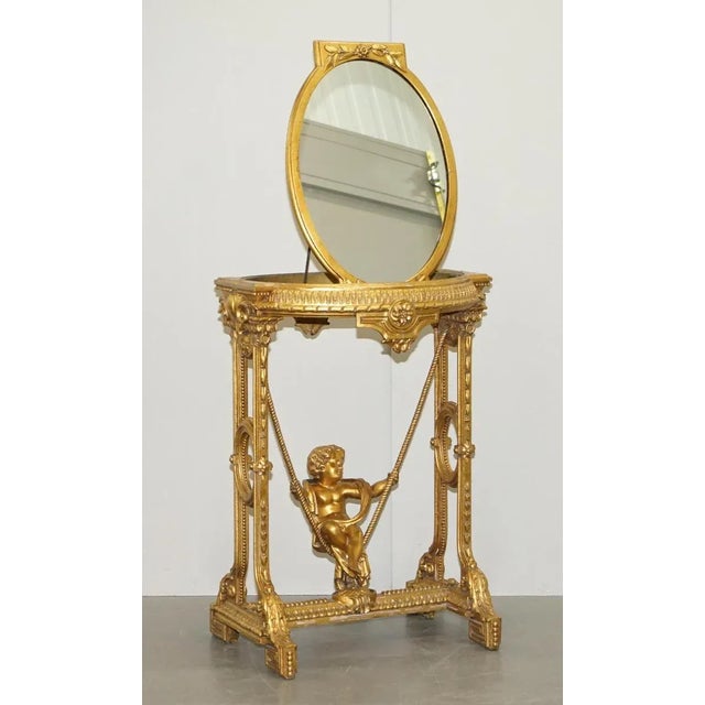 Lovely circa 1920s gold giltwood gesso occasional table with mirror top and putti on swing base A lovely piece, this...