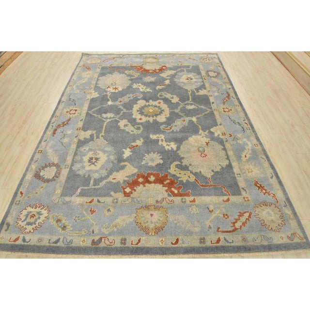 This modern traditional Anatolia rug is hand-knotted with an all-wool pile on a cotton foundation. This rug is new and in...
