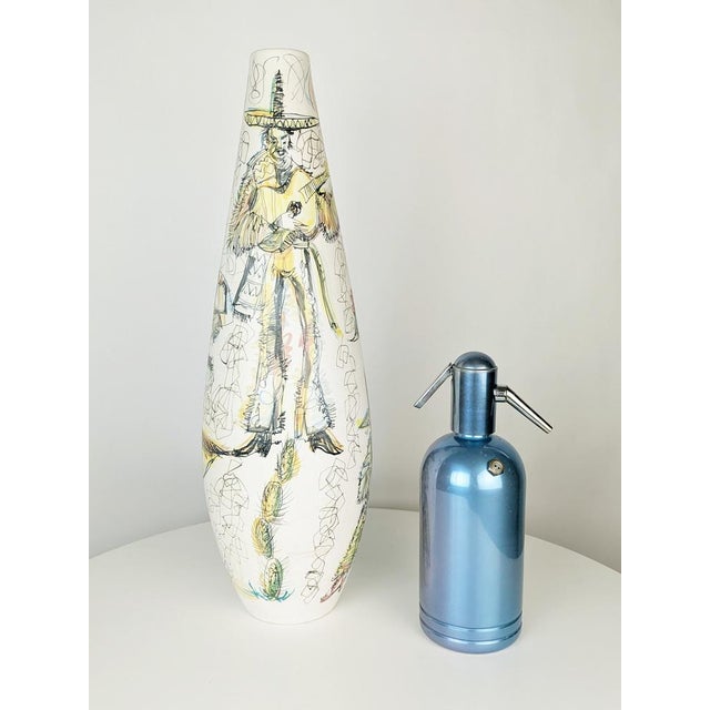 A splendid, large white ceramic vase, finely hand-decorated with mariachi scenes. The surface is entirely covered in...