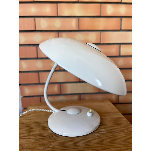 This is an original Bauhaus desk lamp, made of brass, from the 1950s by Helo Leuchten. The inside of the base contains an...