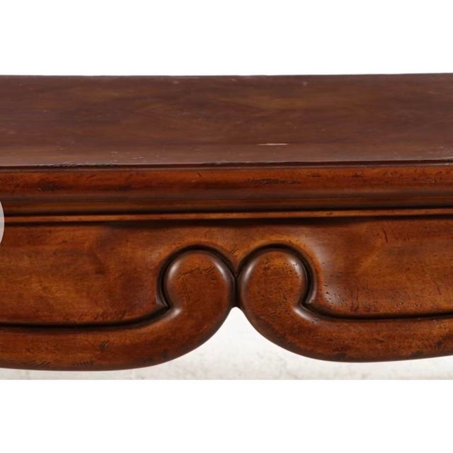 Dating to the late 20th century, this vintage console table is crafted from mahogany and features a rectangular top with...