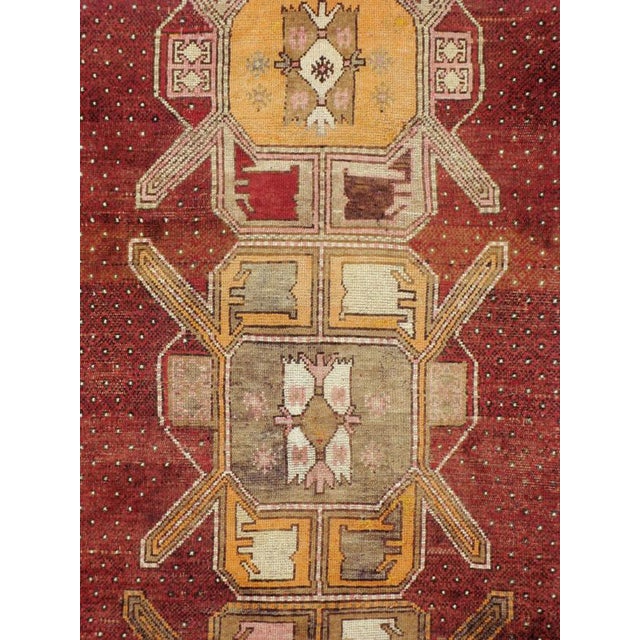 A vintage Turkish Anatolian carpet from the second quarter of the 20th century with four geometric medallions over a...