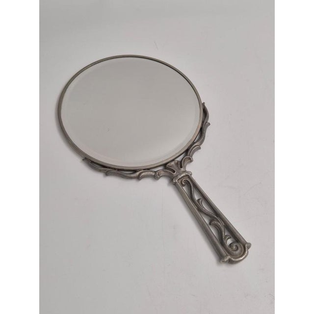 A Swedish Grace hand mirror in pewter with beautiful decor, Sweden 1937 (L8). with hallmarks, marked Svenskt Tenn. with...