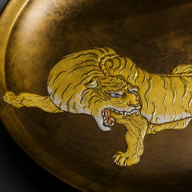 This handcrafted decorative plate features a powerful tiger motif inspired by the renowned Dragon-and-Tiger paintings of...