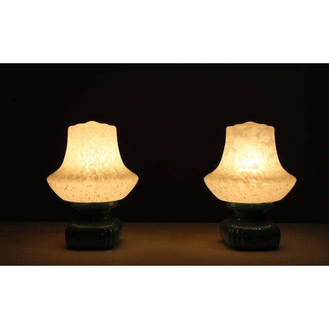 Green glazed ceramic lamps with glass shades from the 1970s, made in the Czech Republic. The lamps are in good vintage...