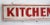 Circa 1940s red and white wood hand lettered two sided Kitchenettes motel sign. Sign has original hooks for hanging. Sign...