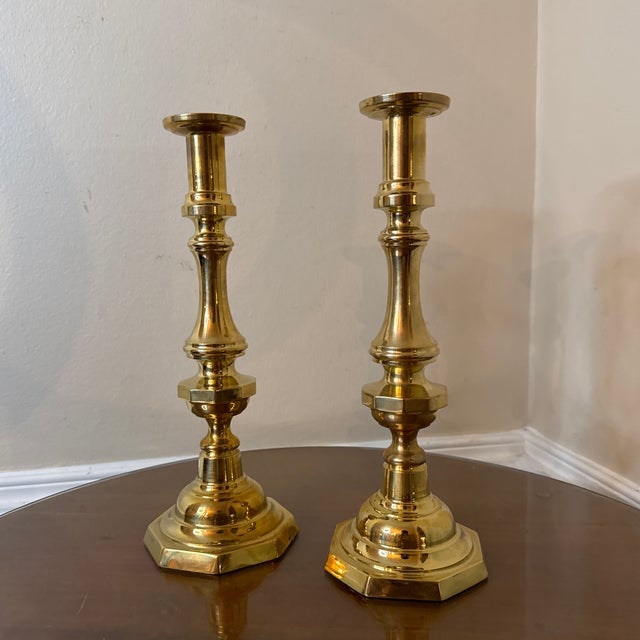 Elevate your home decor with this elegant pair of vintage solid brass candlestick holders. Featuring a timeless,...