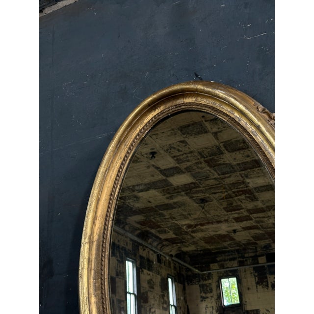 Large 19th Century gold gilt oval mirror with very nice dimensional frame. Can be hung vertically or horizontally.