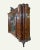 Antique Italian burl walnut bombe armoire from the late 19th century, featuring a carved crest and a central beveled glass...