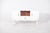 Sideboard painted white. The sideboard is marked by sinuous lines in the door cut-outs and the central niche, as well as...