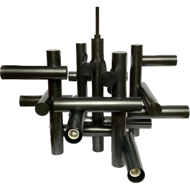 Modern tubular Milano chandelier by Jonathan Alder, for Robert Abbey. This sculptural tiered statement chandelier features...