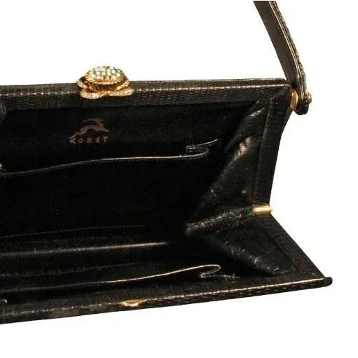 Elegant, tasteful yet eye-catching at the same time! The sleek lines of this black lizard evening purse epitomize the...