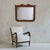 An Italian neoclassical wall mirror from the 19th century, carved in warm cherry wood. The crest unfolds in a gentle arch...