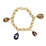 Fabergé, 18k Yellow Gold and Enamel Egg Charm Bracelet For Sale