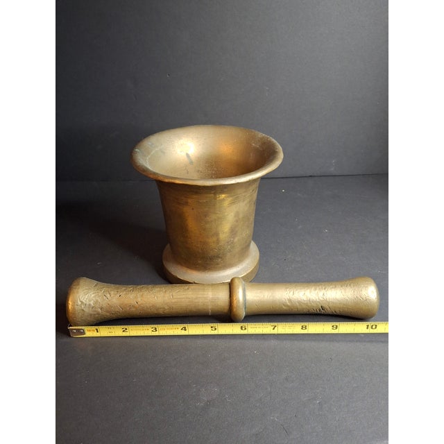 An exceptionally rare, collector-grade antique Western European cast bell metal brass mortar and matching pestle, boasting...