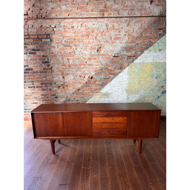 A masterclass in Scandinavian restraint and sculptural form, this Norwegian mid-century sideboard embodies the quiet...