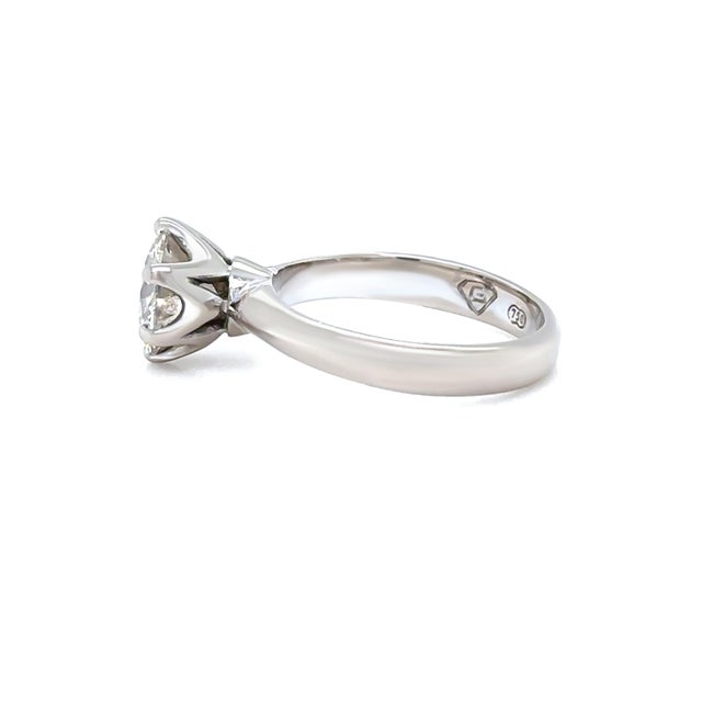A classic diamond solitaire ring crafted in 18ct white gold, showcasing a beautiful champagne-coloured round brilliant cut...